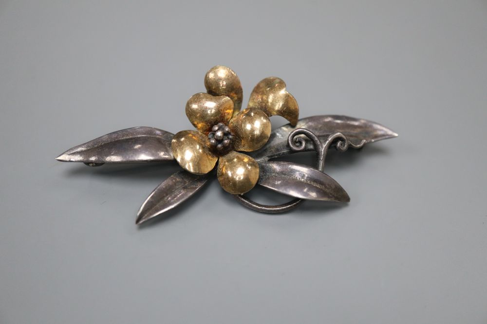 A continental 9ct and white metal (stamped silver) flower and leaf spray brooch, makers mark B.I.?, 62mm, gross 10 grams.